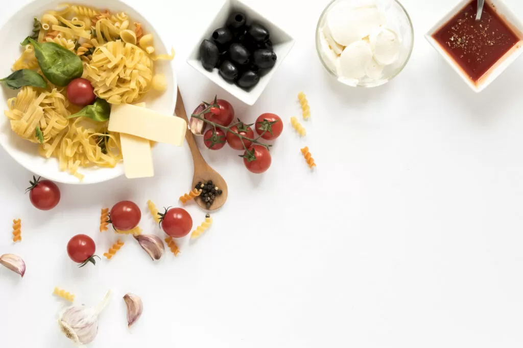 overhead view raw pasta it s ingredients isolated white surface